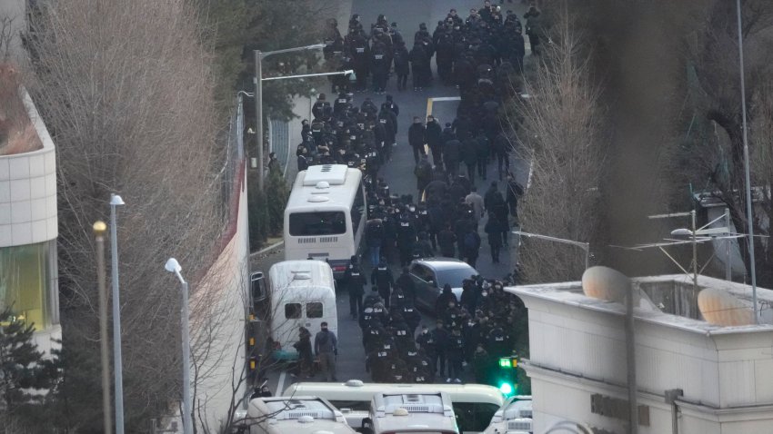 Investigadores de la agencia estatal anticorrupción y policías ingresan al complejo del presidente Yoon Suk Yeol, quien se encuentra suspendido del cargo, para ejecutar una orden para su detención, el miércoles 15 de enero de 2025, en Seúl, Corea del Sur. (AP Foto/Ahn Young-joon)